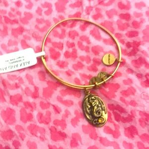 Alex and Ani gold “Dragon” bracelet.